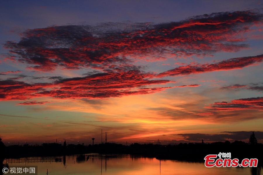 Crimson clouds at sunset hang over the sky in Shaoxing City, Zhejiang Province, Aug. 14, 2018, after the typhoon Yagi. (Photo/VCG)