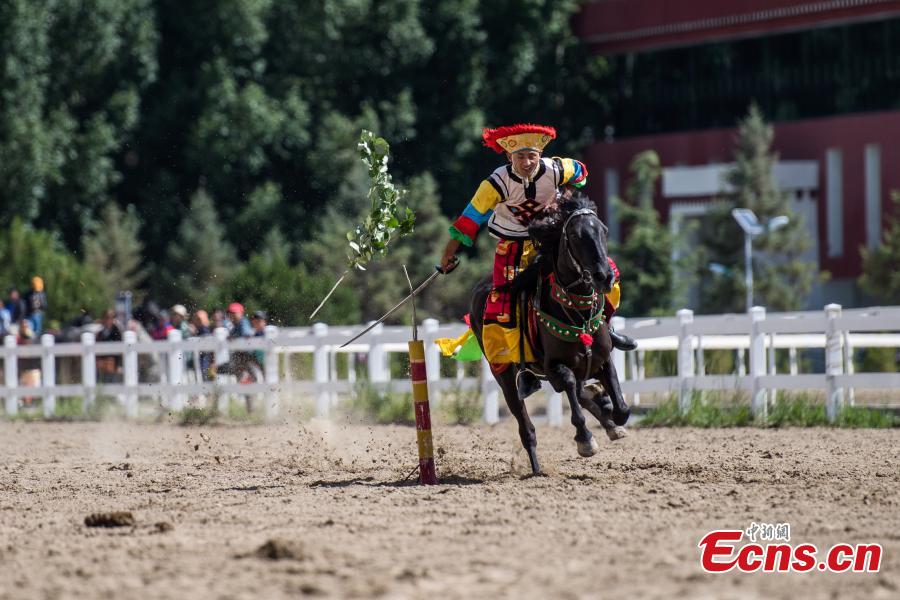 <?php echo strip_tags(addslashes(An equestrian puts on a display of traditional horsemanship skills during the Shoton Festival, commonly known as the Yogurt Festival, in Lhasa, Southwest China’s Tibet Autonomous Region, Aug. 13, 2018. Equestrians performed ten kinds of stunts while riding a horse, including archery and toasting. (Photo: China News Service/He Penglei))) ?>
