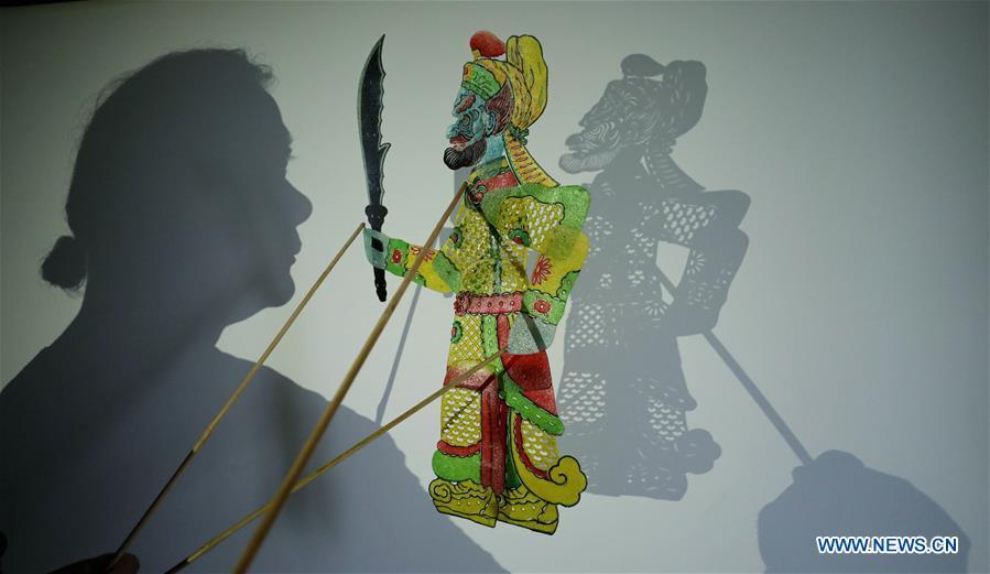 Li Wei shows a shadow puppet he made in Jinan, east China\'s Shandong Province, Aug. 14, 2018. Li, 63, is the son of Jinan shadow puppet show master Li Xingtang. He learned shadow puppet performance from his father in childhood. After his father passed away 11 years ago, Li Wei took over the task of developing and innovating the art of Jinan puppet show. Since last summer, Li has kept on presenting traditional shadow puppet plays at the Baihuazhou scenic area in Jinan every weekend for the public for free. (Xinhua/Zhao Xiaoming)
