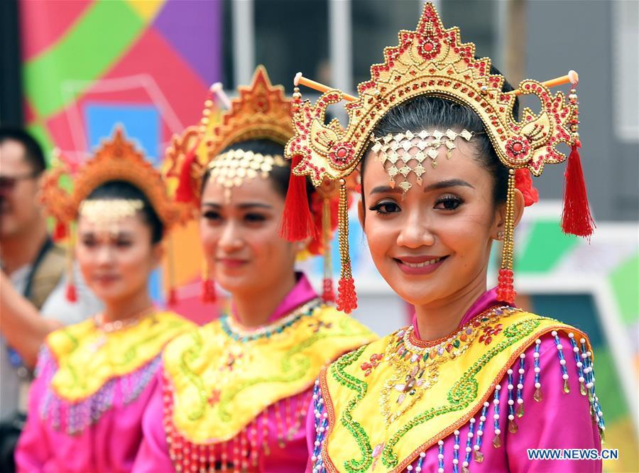 <?php echo strip_tags(addslashes(Etiquette team members in Indonesian folk costume attend flag-raising ceremonies at the Asian Games Village ahead of the 18th Asian Games in Jakarta, Indonesia, on Aug. 16, 2018. (Xinhua/Wang Yuguo))) ?>