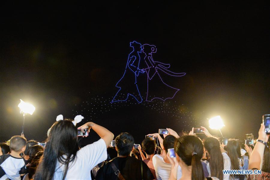 People view drones performance at the Orange Isle scenic area in Changsha, central China\'s Hunan Province, Aug. 16, 2018. Groups of drones performed a light show here to greet the Qixi festival, or Chinese Valentine\'s Day, which falls on Aug. 17 this year. (Xinhua/Zhang Xiaoyu)