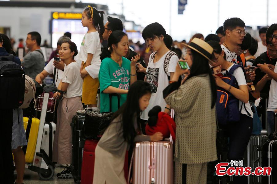 <?php echo strip_tags(addslashes(Passengers wait at the departure hall of Pudong International Airport in Shanghai, Aug. 17, 2018. Some flights in Hongqiao International Airport and Putong International Airport in Shanghai were delayed or cancelled due to the Typhoon Rumbia. （Photo: China News Service/Yin Liqin）)) ?>