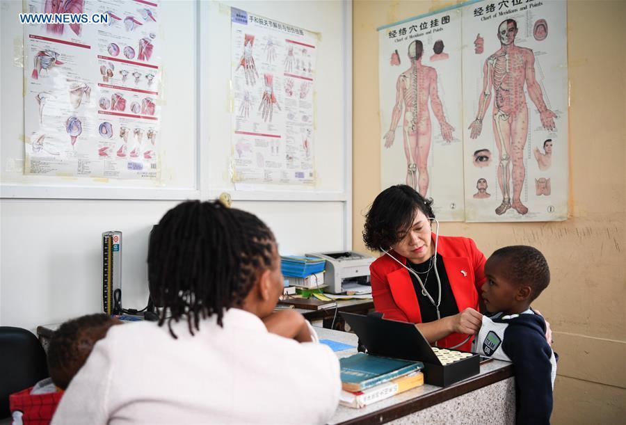 Pan Lianxue examines a local child at her clinic in Nairobi, Kenya, Aug. 17, 2018. Pan Lianxue and her husband Luo Zhanliang, both Chinese doctors in traditional Chinese medicine, have been operated a clinic in Nairobi for over 20 years attracting more and more African patients. China issued the first Medical Workers\' Day on Aug. 19.(Xinhua/Li Yan)