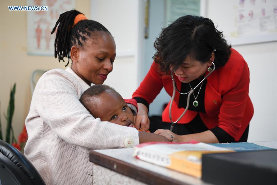 Pan Lianxue examines a local child at her clinic in Nairobi, Kenya, Aug. 17, 2018. Pan Lianxue and her husband Luo Zhanliang, both Chinese doctors in traditional Chinese medicine, have been operated a clinic in Nairobi for over 20 years attracting more and more African patients. China issued the first Medical Workers\' Day on Aug. 19.(Xinhua/Li Yan)