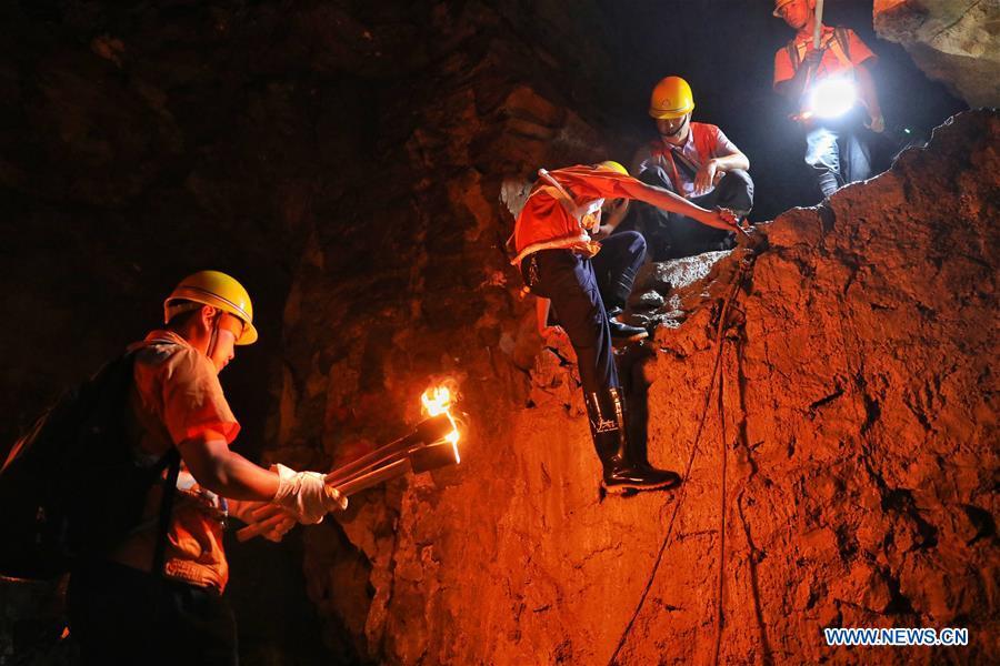 Staff members eat lunch in front of the Yindongpo Tunnel of Guizhou-Guangxi Railway in Duyun City, southwest China\'s Guizhou Province, Aug. 20, 2018. Railway maintenance workers here patrolled the 8.5-kilometer tunnel and took necessary measures to ensure the safety of railway transportation during the flood season. (Xinhua/Liu Xu)