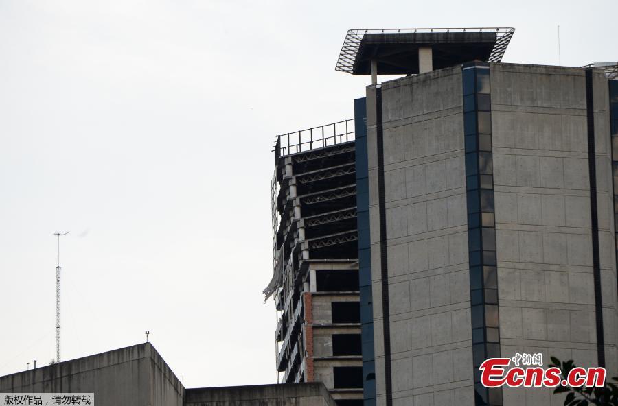 Structural damage is seen on the top five floors of an abandoned 45-storey skyscraper known as the \