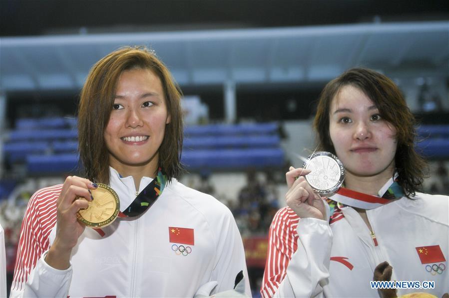 <?php echo strip_tags(addslashes(Liu Xiang (L) of China celebrates during the awarding ceremony after women's 50m backstroke final of swimming at the 18th Asian Games in Jakarta, Indonesia, Aug. 21, 2018. Liu won the gold with 26.98 seconds and set a new world record. (Xinhua/Li Xiang))) ?>