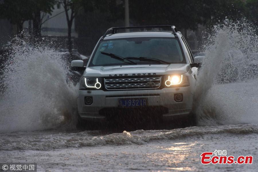 A street floods after a rainstorm in Qionghai City, Hainan Province on Aug. 22, 2018. The local weather bureau issued a warning against thunderstorm and strong winds with it. (Photo/VCG)