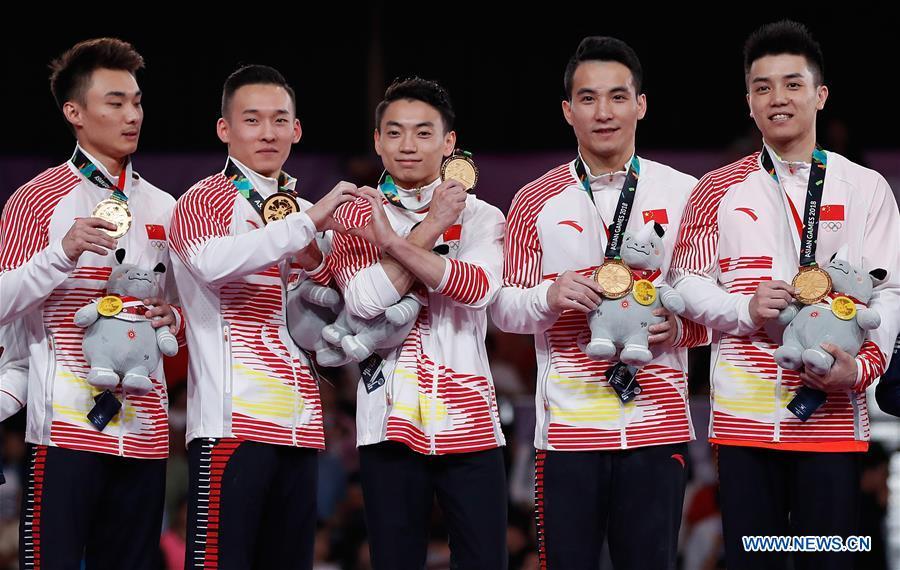 Sun Wei, Xiao Ruoteng, Zou Jingyuan, Deng Shudi and Lin Chaopan (From L to R) of China celebrate during the awarding ceremony for Artistic Gymnastics Men\'s Team Final at the Asian Games 2018 in Jakarta, Indonesia on Aug. 22, 2018. (Xinhua/Wang Lili)