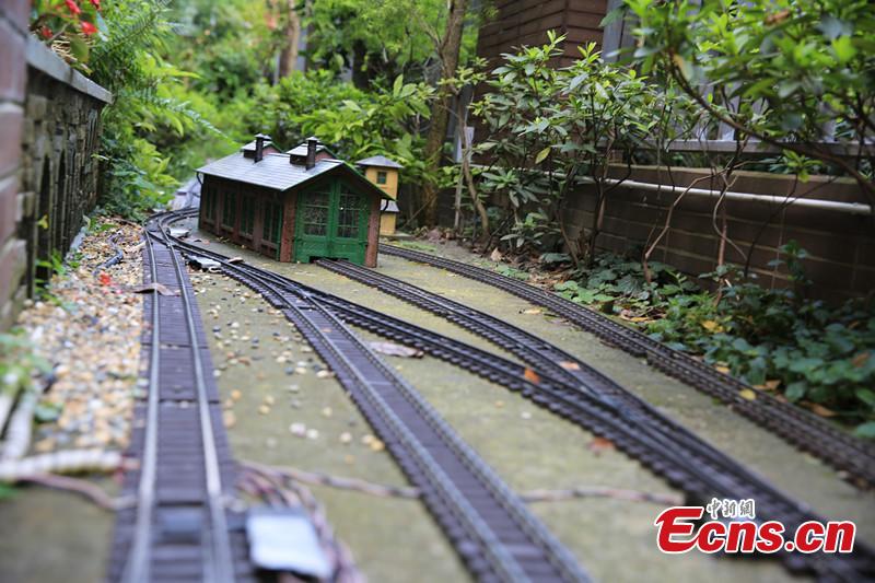 Zhang Yong’an, 63, and his family members have spent five years and more than one million yuan ($145,000) building a ‘train kingdom\' in their 330-sqm home garden in Wenjiang District, Chengdu City, Southwest China’s Sichuan Province. A great fan of train models from an early age, Zhang has tried his best to present every part of a real railway station with vivid models, including train lights, tunnels, passengers, platforms, freight trains and passenger trains. When it rains, Zhang drives all the trains indoors by remote control. (Photo: China News Service/Wu Pinghua)