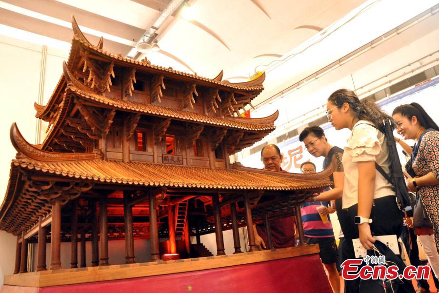 A view of a replica of Zhenwu Pavilion, made with using 3,000 wooden parts by farmer Qin Shikun, during a crafts exhibition in Nanning City, South China’s Guangxi Zhuang Autonomous Region, Aug. 24, 2018. It took Qin one and a half years to complete the miniature version of Zhenwu Pavilion, a famous Taoism pavilion for God Zhenwu in Rongxian County of Guangxi, at a scale of 1:10. (Photo: China News Service/Huang Yanmei)