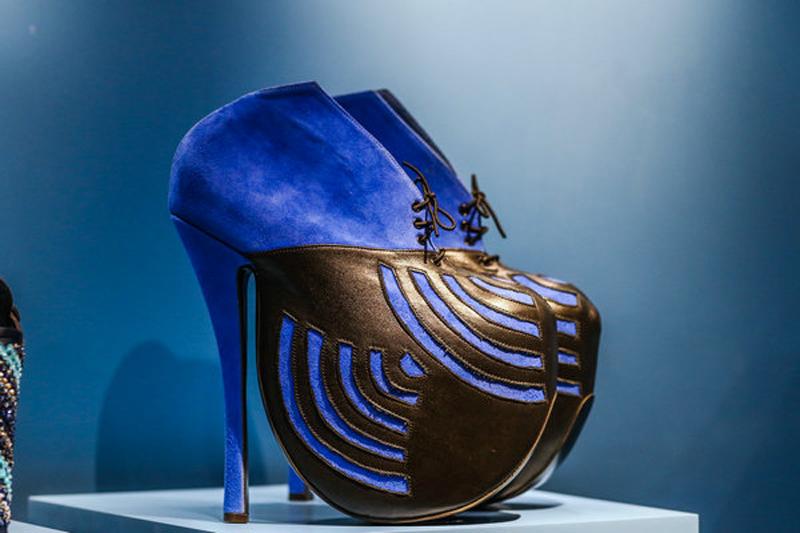 Shoes displayed at the ongoing exhibition.[Photo provided to China Daily]

Bath clogs at 28.5 centimeters high used to be commonly seen in the Ottoman Empire. And they later became a symbol of wealth and status.


In the fourth section, the exhibition also shows how shoes reflect changing tastes.


Here, the Chinese shoe uppers have elaborate embroidery and glass beads stitched on; and there are high heels in baby blue made of silk, silver, wood and decorated with parakeet wings in the same color.


In the last section, the exhibition shows how obsessed people can be with footwear.


Here, there is a big showcase. And all of the shoes and yellow shoe boxes inside belong to a male collector named Lionel Bussey.