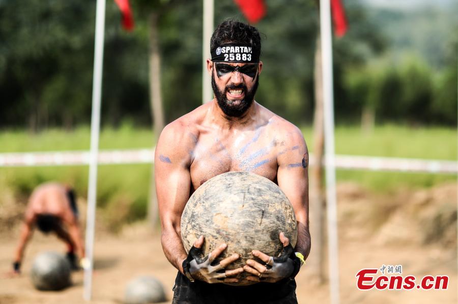 <?php echo strip_tags(addslashes(A participant competes in the 2018 Beijing Spartan Trifecta Weekend in Beijing, Aug. 26, 2018. More than 15,000 contestants participated in the obstacle course race that included three events of differing difficulty levels. (Photo: China News Service/Fu Tian))) ?>