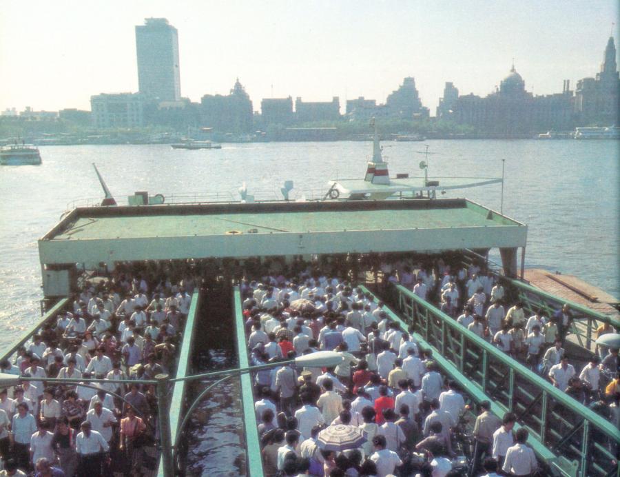 <?php echo strip_tags(addslashes(Past: Commuters swarm onboard a ferry on the east bank of the Huangpu River in 1987. Ferries, the only public means of crossing the river in the 1980s, carried more than 1 million people every day at the time. During the rush hour, a vessel could be crammed with as many as 1,400 people.)) ?>