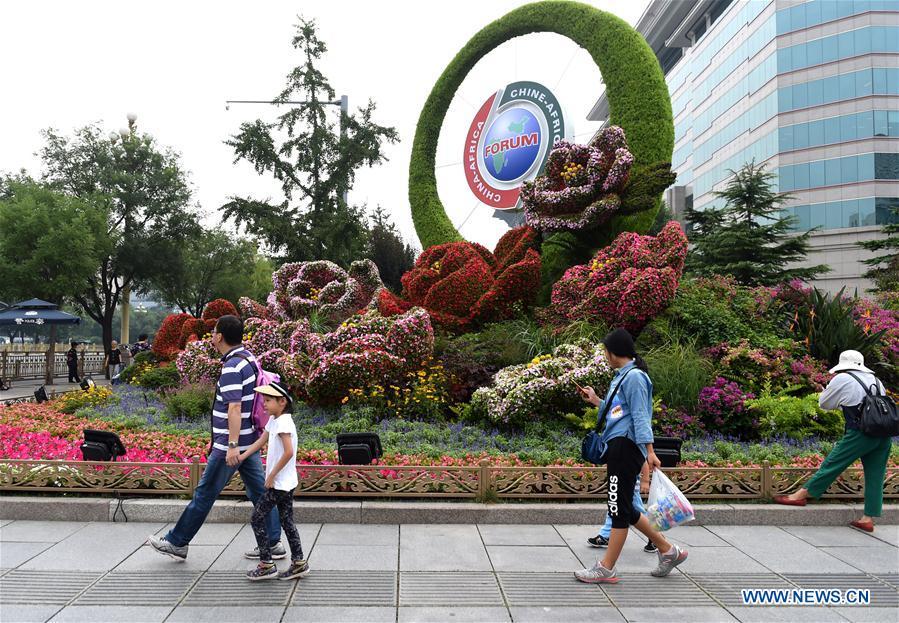 People walk past a parterre to greet the 2018 Beijing summit of the Forum on China-Africa Cooperation (FOCAC) in Beijing, capital of China, Aug. 28, 2018. The summit is scheduled for Sept. 3-4 in Beijing. (Xinhua/Luo Xiaoguang)