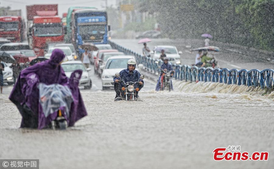 <?php echo strip_tags(addslashes(Motorcyclists drive on a flooded road after a rainstorm in Quanzhou City, East China’s Fujian Province, Aug. 29, 2018. (Photo/VCG))) ?>