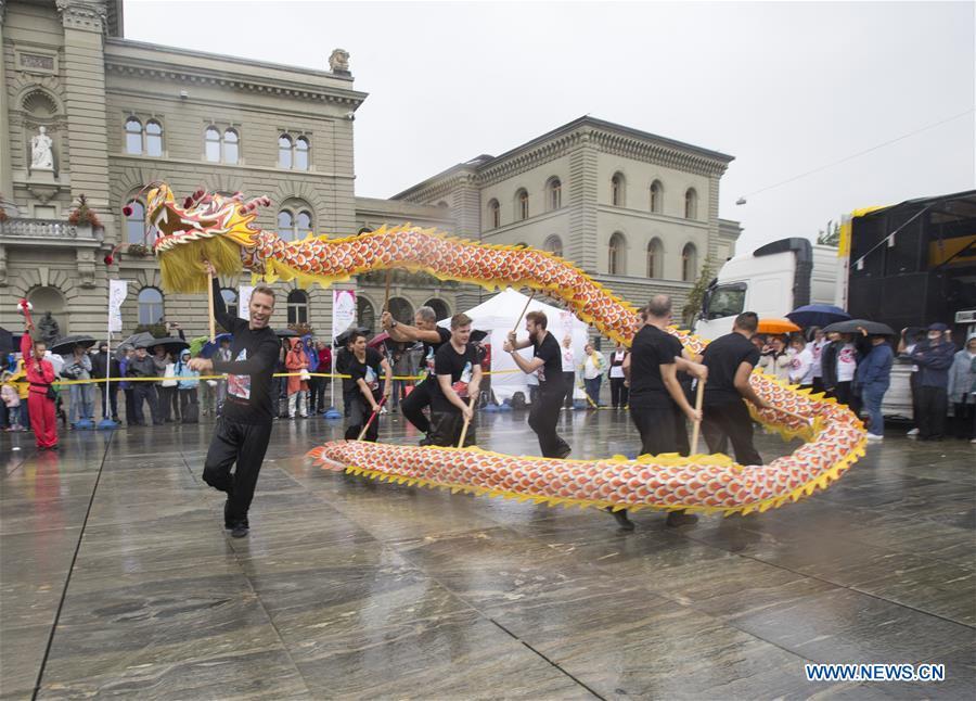 People perform dragon dance during the \