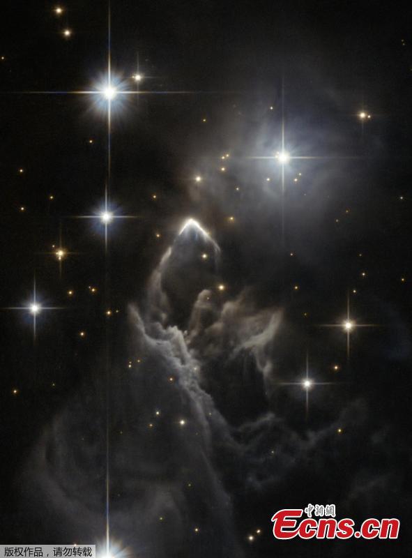 The little-known nebula IRAS 05437+2502 billows out among the bright stars and dark dust clouds that surround it in this striking image from the Hubble Space Telescope. It is located in the constellation of Taurus (the Bull), close to the central plane of our Milky Way galaxy. Unlike many of Hubble’s targets, this object has not been studied in detail and its exact nature is unclear. This faint cloud was originally discovered in 1983 by the Infrared Astronomical Satellite (IRAS), the first space telescope to survey the whole sky in infrared light. (Photo/NASA)