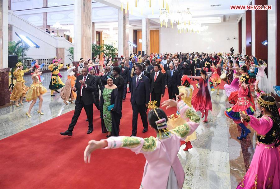 Foreign leaders and their spouses attending the Beijing Summit of the Forum on China-Africa Cooperation (FOCAC) are greeted by young performers on their way to a welcoming banquet held by Chinese President Xi Jinping and his wife Peng Liyuan at the Great Hall of the People in Beijing, capital of China, Sept. 3, 2018. (Xinhua/Shen Hong)