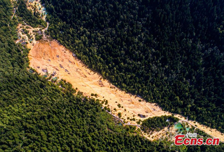 An aerial view of the Huanglong scenic area in Sichuan Province. A UNESCO World Heritage site, the area is known for its colorful pools formed by calcite deposits, especially in Huanglonggou (Yellow Dragon Gully), as well as diverse forest ecosystems, snow-capped peaks, waterfalls and hot springs. The Wucai Pond (Five-Colored Pond) is one of its top attractions. (Photo: China News Service/Yang Jian)