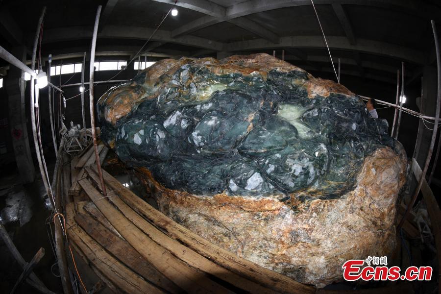 A view of a single, 118-ton jade rock in Xiuyan Manchu Autonomous County, Liaoning Province, Sept. 5, 2018. Chinese artists have started creating the world’s largest jade sculpture of the Great Wall, made from the boulder, which measures 6.5 meters long, three meters high and four meters wide, with the largest diameter 17 meters. The rock has a 98 percent jade content, three times higher than that usually found in jade rocks. The sculpture is set to be completed in one year, in time for National Day on Oct. 1, 2019. (Photo: China News Service/Sun Zifa)
