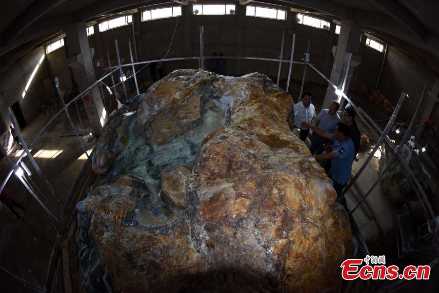 A view of a single, 118-ton jade rock in Xiuyan Manchu Autonomous County, Liaoning Province, Sept. 5, 2018. Chinese artists have started creating the world’s largest jade sculpture of the Great Wall, made from the boulder, which measures 6.5 meters long, three meters high and four meters wide, with the largest diameter 17 meters. The rock has a 98 percent jade content, three times higher than that usually found in jade rocks. The sculpture is set to be completed in one year, in time for National Day on Oct. 1, 2019. (Photo: China News Service/Sun Zifa)