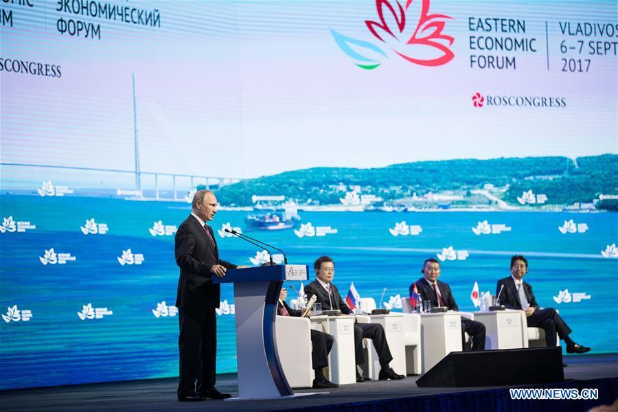 Russian President Vladimir Putin (L) speaks on the plenary session of the third Eastern Economic Forum in Vladivostok, Russia, on Sept. 7, 2017. (Xinhua/Wu Zhuang)
