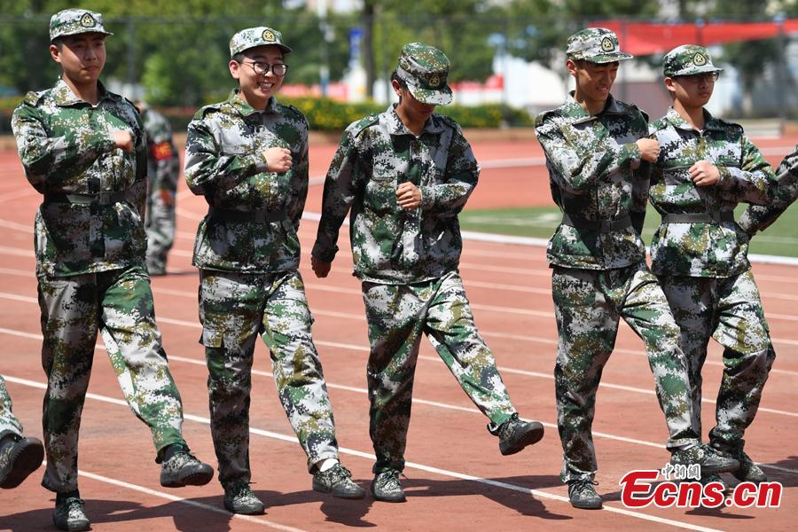 Freshman students from the Yunnan Arts University pose for photos during a compulsory military training in Kunming City, Southwest China’s Yunnan Province, Sept. 6, 2018. Military training, compulsory for freshmen in China\'s colleges, includes a diverse range of programs. (Photo: China News Service/Liu Ranyang)