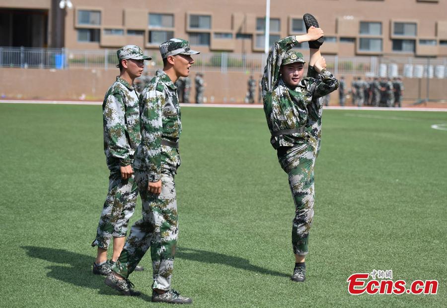Freshman students from the Yunnan Arts University pose for photos during a compulsory military training in Kunming City, Southwest China’s Yunnan Province, Sept. 6, 2018. Military training, compulsory for freshmen in China\'s colleges, includes a diverse range of programs. (Photo: China News Service/Liu Ranyang)