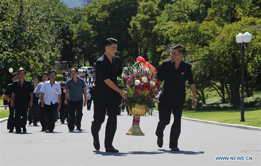 Photo taken on Sept. 8, 2018 shows people presenting a flower basket to the statues of late leaders in Pyongyang, capital of the Democratic People\'s Republic of Korea (DPRK). Sept. 9, 2018 marks the 70th anniversary of the founding of the DPRK. (Xinhua/Jiang Yaping)
