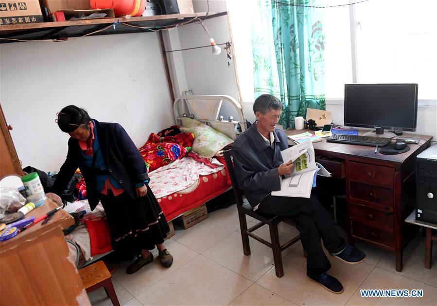 Wang Zhengxiang and his wife Pan Xiuhua are seen at the dormitory of Ayiyang Primary School in Sanmeng Village of Luquan Yi and Miao Autonomous County, southwest China\'s Yunnan Province, Sept. 5, 2018. One teacher, eight students, none was and will be given up thanks to rural teacher Wang Zhengxiang. Wang Zhengxiang of Miao ethnic group, 56, is the only teacher and has been teaching at the remote village primary school of Ayiyang for 38 years. Ayiyang Primary School, lying at an altitude of 2,600 meters above sea level and surrounded by mountains, is not within easy reach of outside world. There are just eight students at the school. Yet Wang takes care of his students with love, consideration and strong sense of responsibility. He buys shoes and daily goods for poverty-stricken students with his own money, and he has tried every means to keep those who wanted to drop out due to economic insufficiency. \