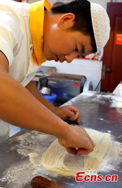 <?php echo strip_tags(addslashes(Mu Numa makes Lamian (hand-pulled noodles) in Hualong Hui Autonomous County, Northwest China’s Qinghai Province, Sept. 10, 2018. After years of practice, Ma is able to twist, stretch and fold the dough into strands thin enough to thread a needle. (Photo: China News Service/Li Juan))) ?>