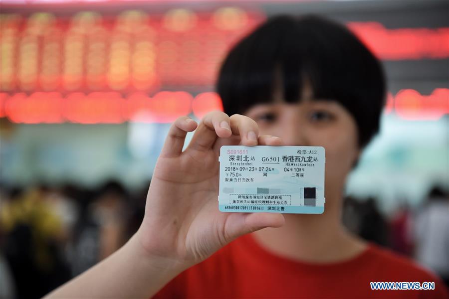 A citizen shows a high-speed railway ticket from Shenzhen North Station to Hong Kong West Kowloon Station in Shenzhen, south China\'s Guangdong Province, Sept. 10, 2018. The Guangzhou-Shenzhen-Hong Kong high-speed railway will officially start operation on Sept. 23. The sale of the tickets began on Monday. (Xinhua/Mao Siqian)