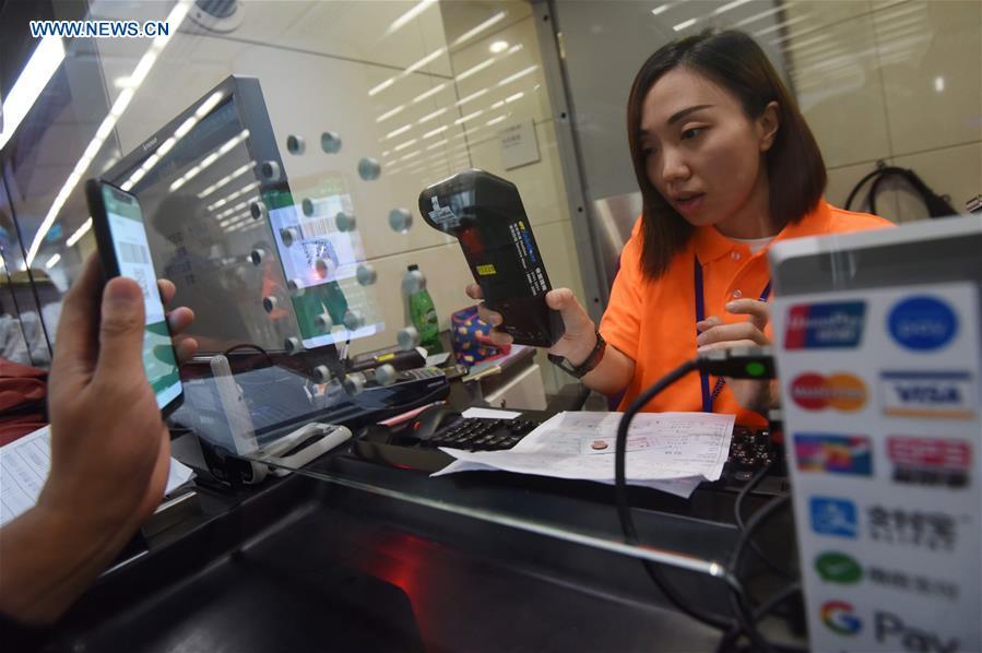 A passenger pays a ticket at the Hong Kong West Kowloon Station, in Hong Kong, south China, on Sept. 10, 2018. The Guangzhou-Shenzhen-Hong Kong high-speed railway will officially start operation on Sept. 23. The sale of the tickets began on Monday. (Xinhua/Wang Shen)