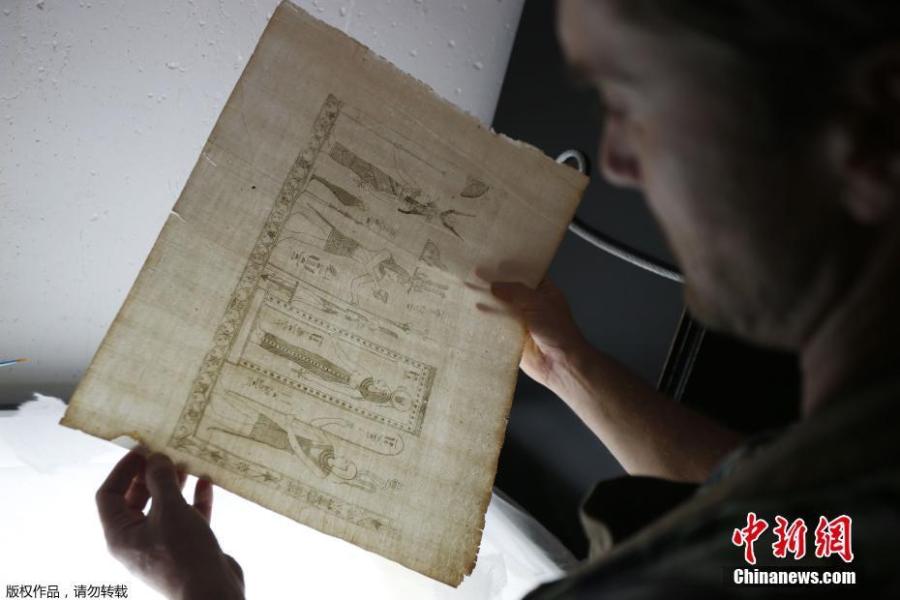 Italian conservator-restorer Simone Martini works on the restauration of the Thesaurus Hyeroglyphicorum book at the Ajaccio library on the French Mediterranean Island of Corsica, Sept. 7, 2018. (Photo/Agencies)