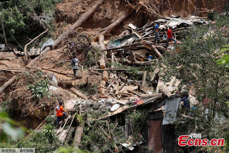 Rescuers dig on the site where victims were believed to have been buried by a landslide after Typhoon Mangkhut barreled across Itogon, Benguet province, northern Philippines, Sept. 17, 2018. Itogon Mayor Victorio Palangdan said that at the height of the typhoon\'s onslaught Saturday afternoon, dozens of people, mostly miners and their families, rushed into an old three-story building in the village of Ucab. The building, a former mining bunkhouse that had been transformed into a chapel, was obliterated when part of a mountain slope collapsed. (Photo/Agencies)