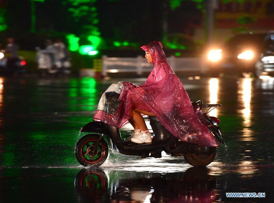 A citizen rides against storm in Yulin, south China\'s Guangxi Zhuang Autonomous Region, Sept. 16, 2018. Local meteorologic authority issued a red warning against typhoon on Sunday. (Xinhua/Huang Xiaobang)