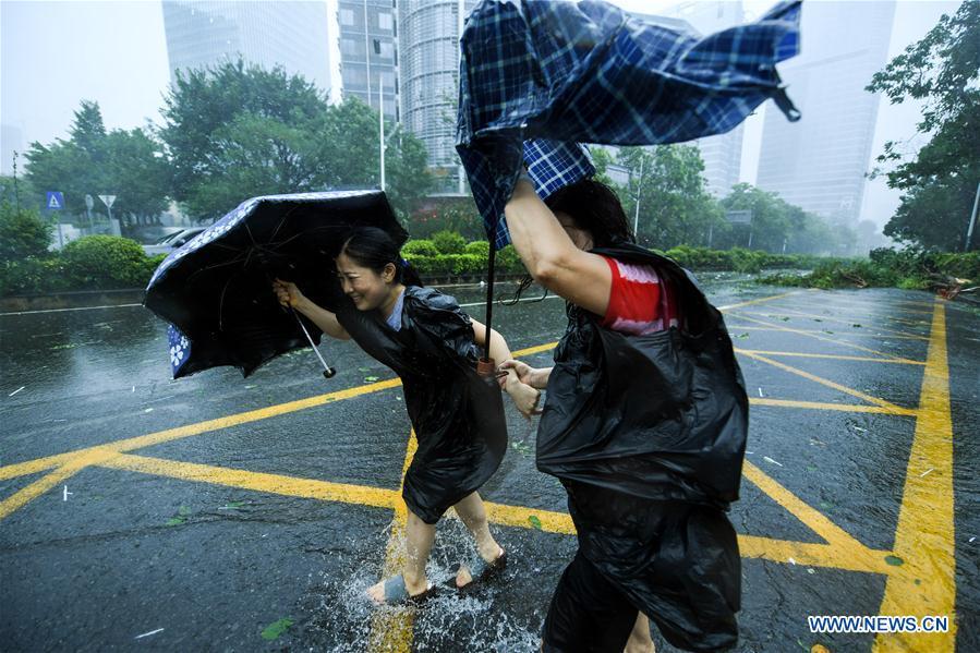Pedestrains walk in the wind at Nanshan District in Shenzhen, south China\'s Guangdong Province, Sept. 16, 2018. According to China\'s National Meteorological Center, Mangkhut is expected to land in Guangdong between Sunday afternoon and evening. (Xinhua/Mao Siqian)