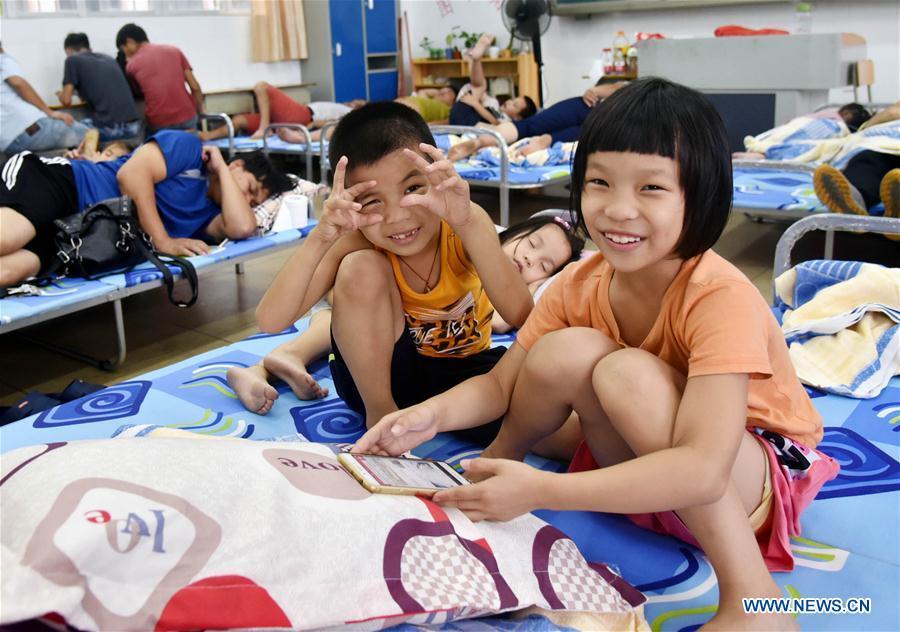 Children play in a temporary shelter at a primary school in Dongping Town of Yangjiang, south China\'s Guangdong Province, Sept. 16, 2018. Super Typhoon Mangkhut landed at 5 p.m. on Sunday on the coast of Jiangmen City, south China\'s Guangdong Province. Some 600 people from disaster-prone areas in Dongping have been relocated. (Xinhua/Zhou Ke)