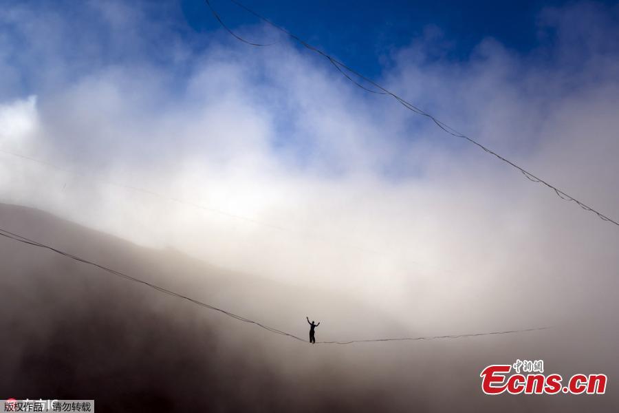 A picture taken with a drone shows a highliner performs during the Highline Extreme event on the top of the Moleson peak at 2000 meters above the sea level, in the Swiss Alps, near Gruyeres, Switzerland, Sept. 15, 2018. Twenty-five of the world’s best slackliners compete from Sept. 13 to 16, on 6 different lines ranging from 45 meters to 480 meters. Balancing on the \'slackline\' is a training method for climbers to improve their equilibrium sense. To avoid the danger of falling down, the athlete is secured with a rope. (Photo/Agencies)