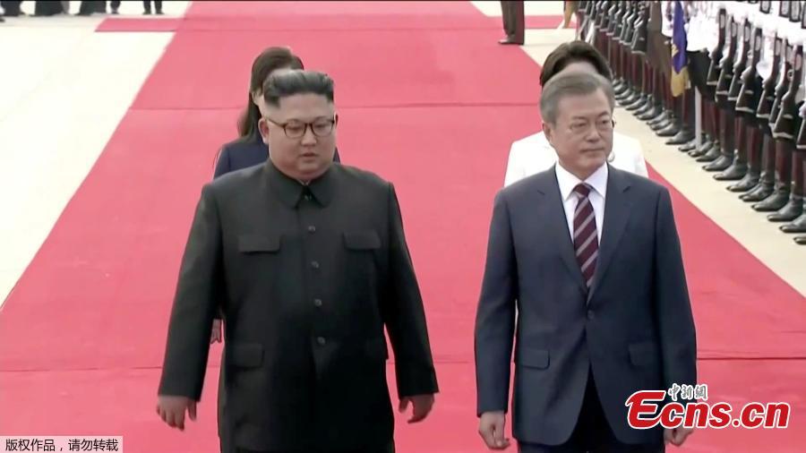In this image made from video, South Korean President Moon Jae-in, right, is welcomed by the Democratic People\'s Republic of Korea leader Kim Jong Un for a photo on the podium upon arrival in Pyongyang, Sept. 18, 2018. Moon landed in Pyongyang for his third summit this year with Kim. (Photo/Agencies)