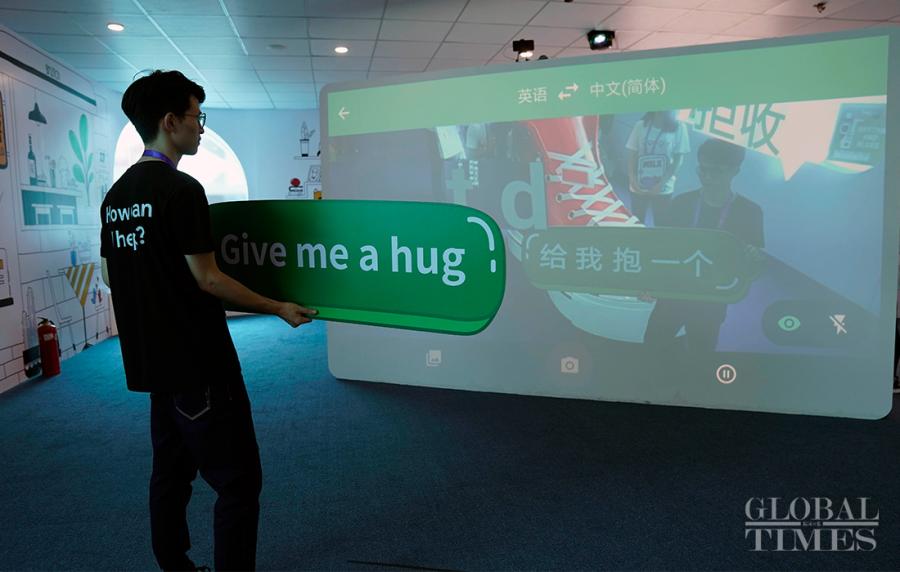 A man interacts with the Google AI translator. (Photo: Yang Hui/GT)