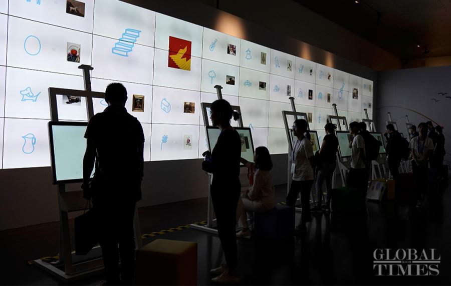 People interact with a Google painting system, which matches world-renowned paintings with people\'s sketches. 
(Photo: Yang Hui/GT)