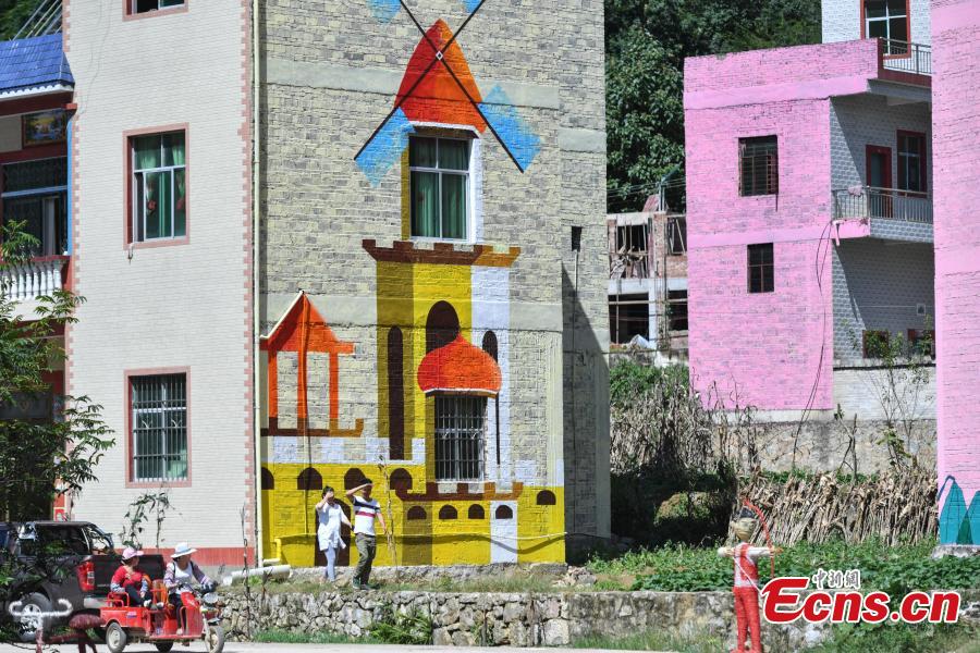 <?php echo strip_tags(addslashes(A view of the colorful buildings at Heye Village in Guangnan County, Southwest China’s Yunnan Province, Sept. 20, 2018. A group of artists began painting buildings and trees in different colors one month ago in order to help attract tourists to the village. (Photo: China News Service/Ren Dong))) ?>