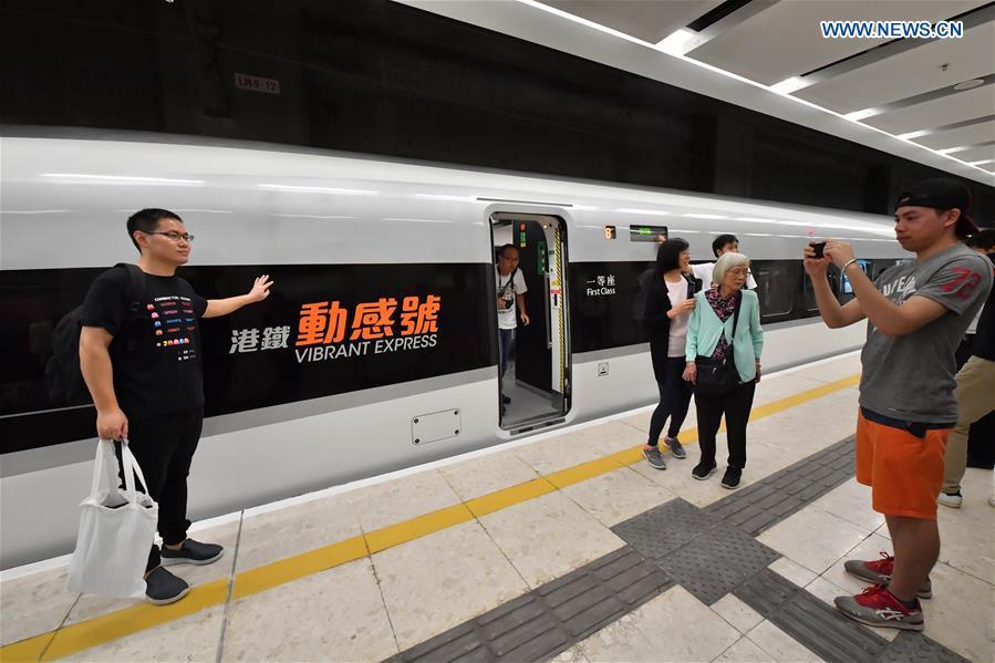 Passengers pose with train G5736 at West Kowloon Station in Hong Kong, south China, Sept. 23, 2018. Train G5736 left Hong Kong West Kowloon Station at 7:00 on Sunday (1100 GMT Saturday) for Shenzhen North Railway Station. At 6:44, train G5711 left Shenzhen North Railway Station for Hong Kong West Kowloon Station, marking the opening of the Hong Kong section of the Guangzhou-Shenzhen-Hong Kong High-speed Railway and that of the whole Guangzhou-Shenzhen-Hong Kong High-speed Railway. (Xinhua/Lui Siu Wai)