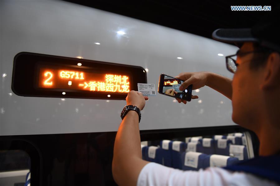 A passenger takes photos of G5711, the first high-speed train from Shenzhen to Hong Kong, at Shenzhen North Railway Station in Shenzhen City, south China\'s Guangdong Province, Sept. 23, 2018. G5711 train left Shenzhen North Railway Station at 6:44 Beijing Time on Sunday (1044 GMT Saturday) for West Kowloon Station in Hong Kong, marking the opening of the Hong Kong section of the Guangzhou-Shenzhen-Hong Kong High-speed Railway and that of the whole Guangzhou-Shenzhen-Hong Kong High-speed Railway. (Xinhua/Mao Siqian)