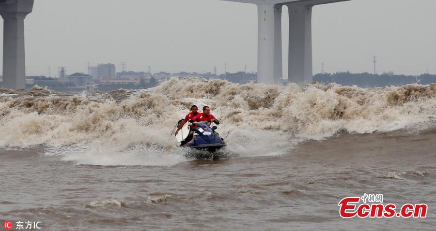 <?php echo strip_tags(addslashes(A jet ski on the Qiantang River in Hangzhou City, East China’s Zhejiang Province, Sept. 26, 2018. More than 100 participants from 11 countries including China, Spain, Australia, the United States, South Africa, Brazil, France and Indonesia participated in the surfing competition. The tidal bores on the river have become a popular tourist attraction in China. (Photo/IC))) ?>