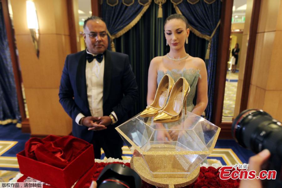 Touted as the world\'s most expensive footwear at $17 million, the Passion Diamond shoes is on display alongside Jada Dubai\'s newly launched collection of jewelled shoes at Burj Al Arab, Dubai, Sept. 26, 2018. Made in collaboration with Dubai\'s Passion Jewellers, the Passion Diamond pair are crafted from real gold, while a D-flawless 15-carat diamond adorns the toe of each stiletto. A total of 236 diamonds line the opening of the shoe where it meets the foot.(Photo/Agencies)