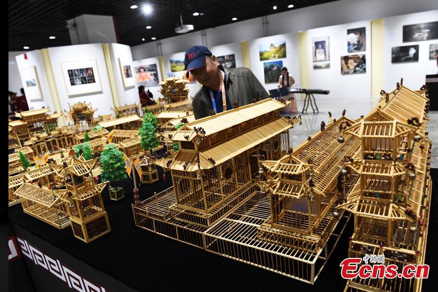 <?php echo strip_tags(addslashes(Craftsman Wu Tianxiang shows a replica of Fuxi Temple in Tianshui City made using bamboo sticks during the Silk Road (Dunhuang) International Cultural Expo in Dunhuang City, Northwest China’s Gansu Province, Sept. 28, 2018. It took Wu five years and 20,000 bamboo sticks to create the miniaturized landscape that measured 4.8 meters long and 4.2 meters wide and included 58 buildings in great details. Each door and window in the model can be opened easily. (Photo: China News Service/Yang Yanmin))) ?>