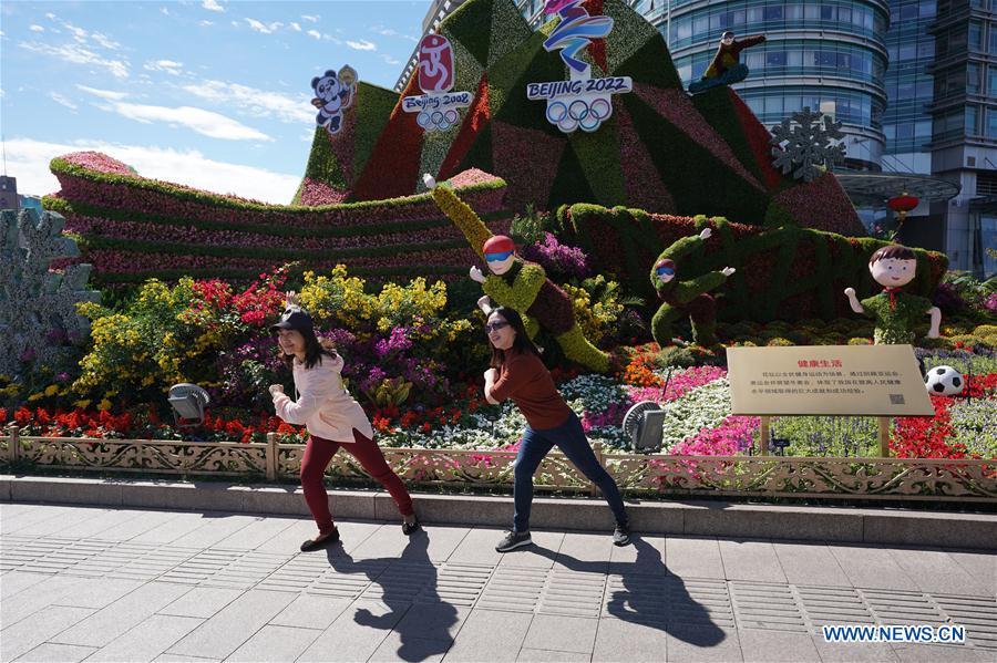 <?php echo strip_tags(addslashes(Two tourists pose for photos with flower parterres in Beijing, capital of China, Sept. 29, 2018. Beijing is decorated with ornamental flower parterres for the upcoming China's National Day. (Xinhua/Ju Huanzong))) ?>